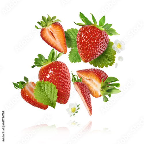 Fototapeta Naklejka Na Ścianę i Meble -  Fresh raw ripe strawberry with green leaves falling in the air, food levitation