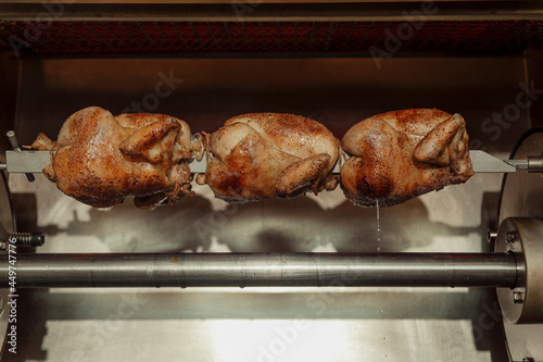 Whole chickens on a rotisserie  photo