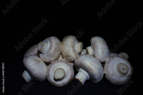 a pile of mushrooms lying on a black background