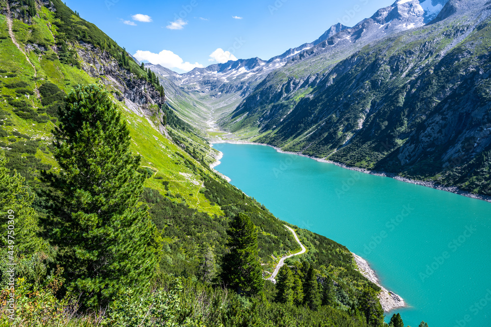 Vivid blue mountain lake in summer Alps. Speicher Zillergrundl dam, Zillertal Alps, Austria