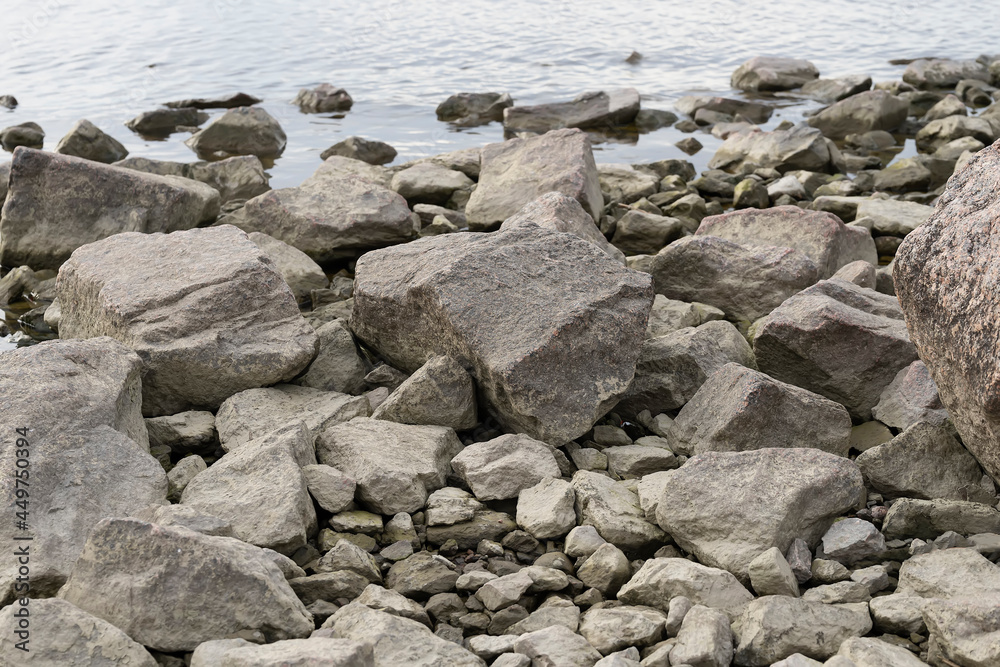 Stone seashore. Stones on the background of water