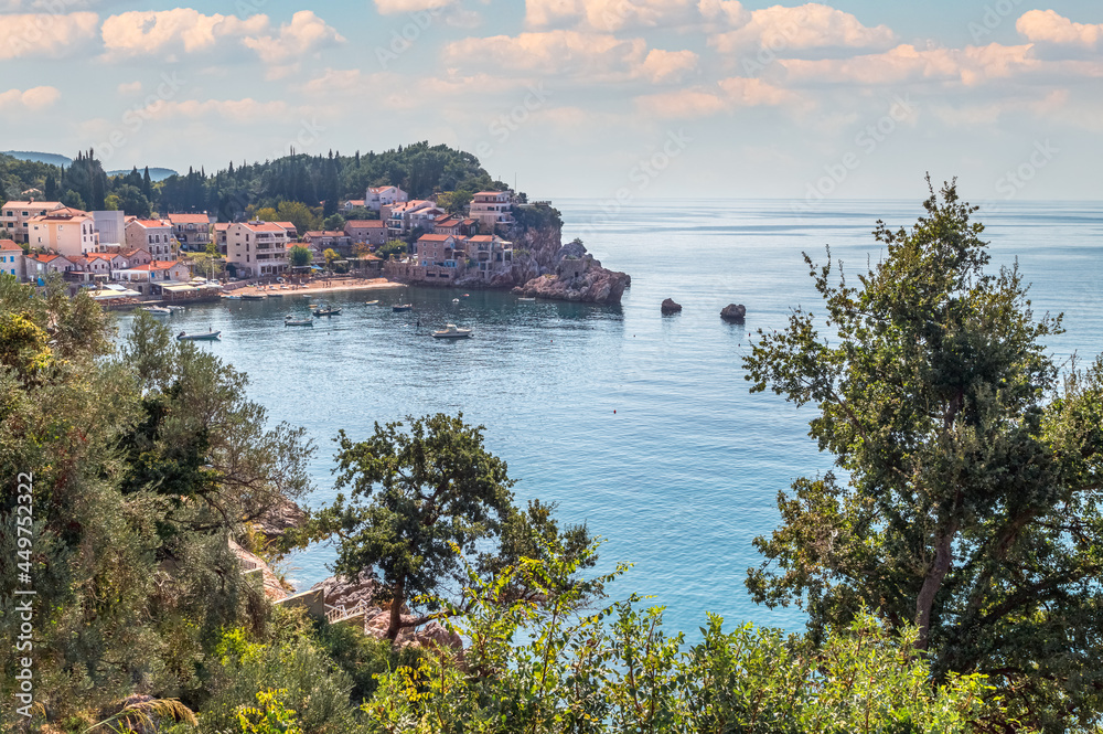 Adriatic sea coast and Przno village with buildings on the rocks in Budva Riviera, Montenegro.