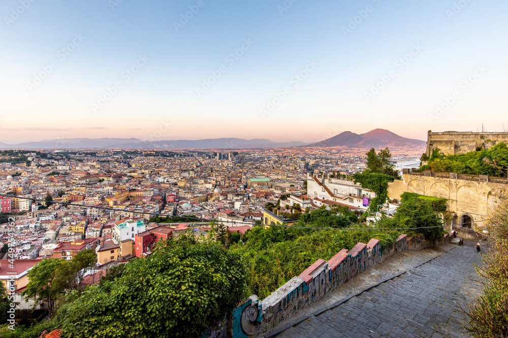 Napoli, Italy - July 11, 2021: Bay of Napoli and Vesuvius volcano in background at sunset in a summer day in Italy, Campania