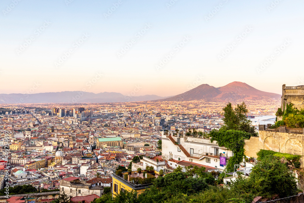 Napoli, Italy - July 11, 2021: Bay of Napoli and Vesuvius volcano in background at sunset in a summer day in Italy, Campania
