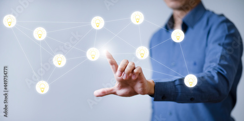 Businessman touchscreen on the light bulb icon graph Screen Icon of a media screen, Technology Process System Business with Communication and marketing.Creativity and innovation are keys to success.