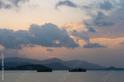 Sunset over the bay with fishing boats