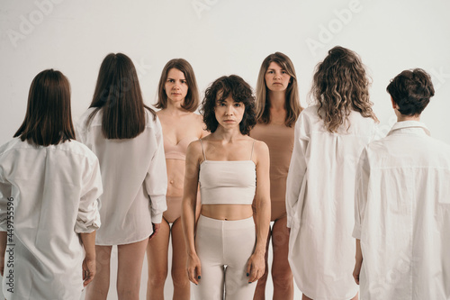Girls with different types of figures stand. Study of female psychology. Connection between people. The ability of people to be themselves in society. Girls are ashamed of their figures