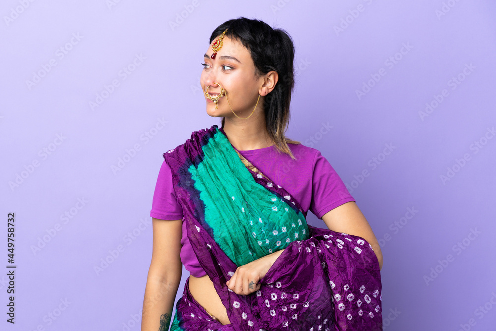 Indian woman isolated on purple background looking side Indian woman isolated on purple background looking side