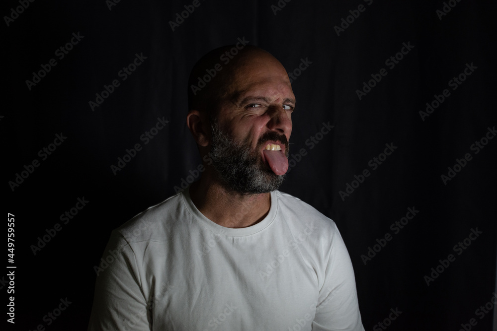 portrait of a man joking with his tongue out portrait of a man joking with his tongue out