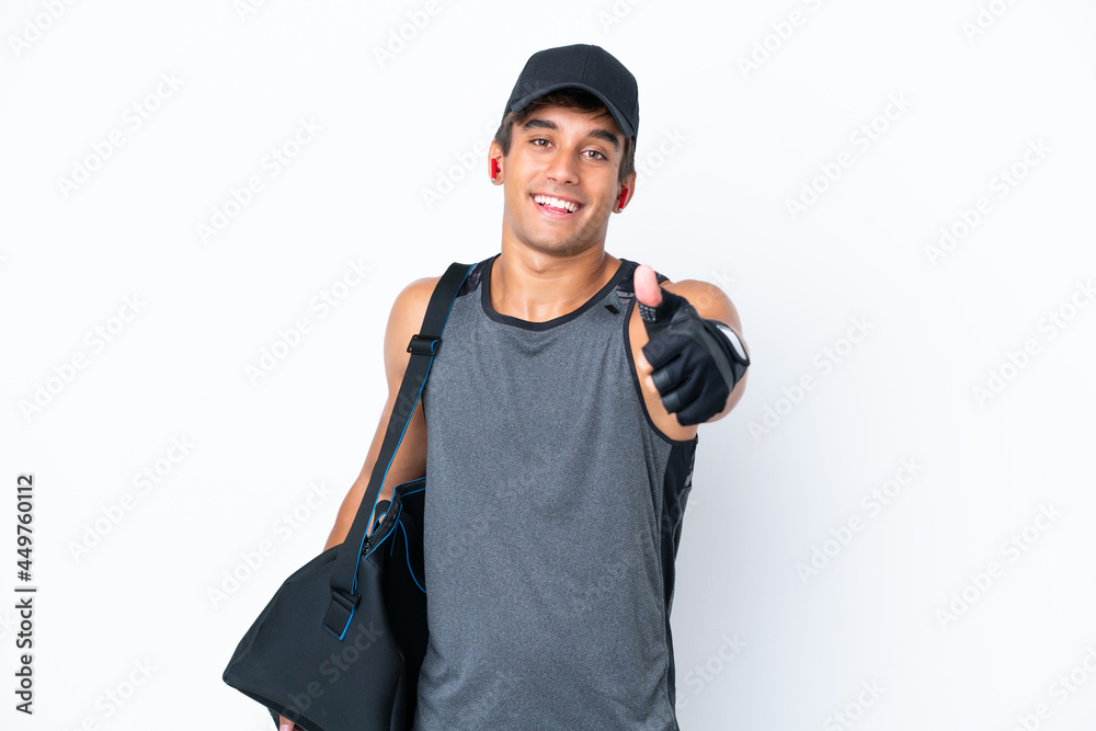 Young sport caucasian man with sport bag isolated on white background with thumbs up because something good has happened Young sport caucasian man with sport bag isolated on white background with thumbs up because something good has happened