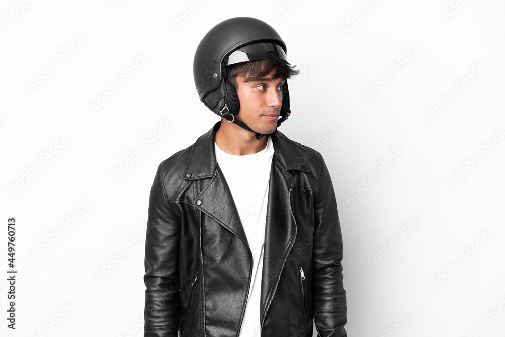 Young man with a motorcycle helmet isolated on white background looking to the side Young man with a motorcycle helmet isolated on white background looking to the side