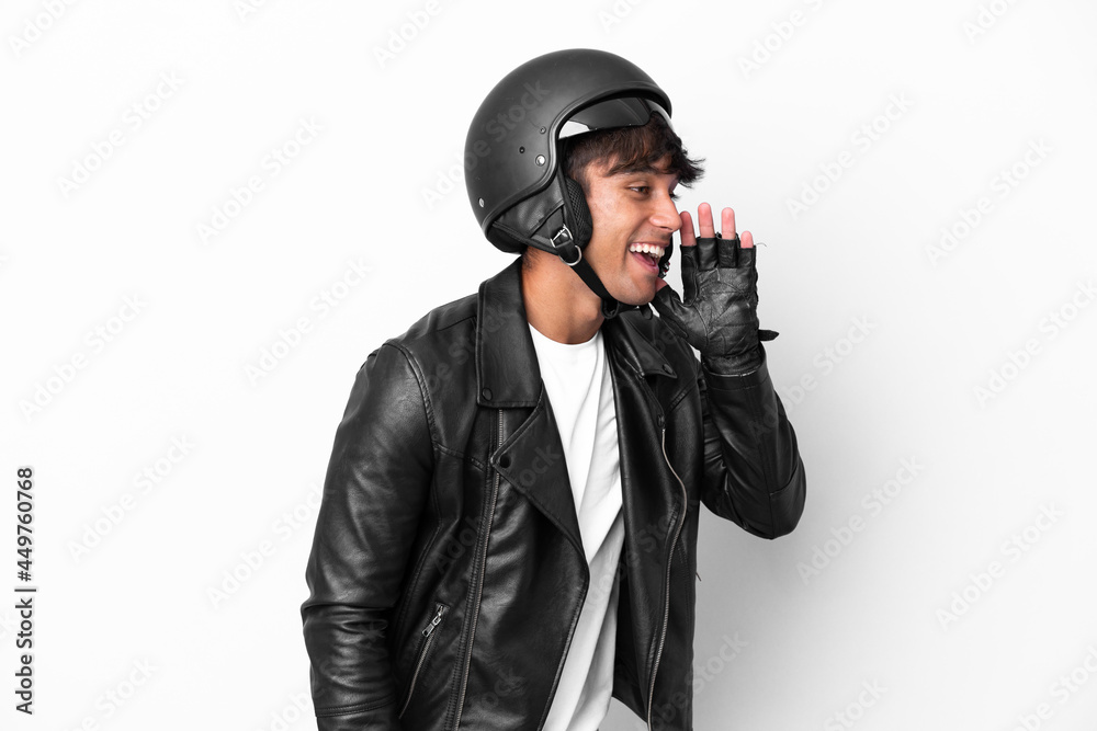 Young man with a motorcycle helmet isolated on white background shouting with mouth wide open to the side Young man with a motorcycle helmet isolated on white background shouting with mouth wide open to the side