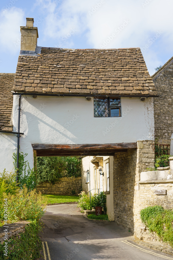 pretty Archway cottage over a road in the Wiltshire UK Cotswold village of Castle Combe