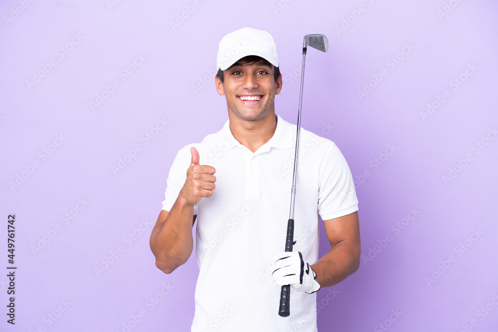 Young caucasian man isolated on purple background playing golf and with thumbs up because something good has happened Young caucasian man isolated on purple background playing golf and with thumbs up because something good has happened