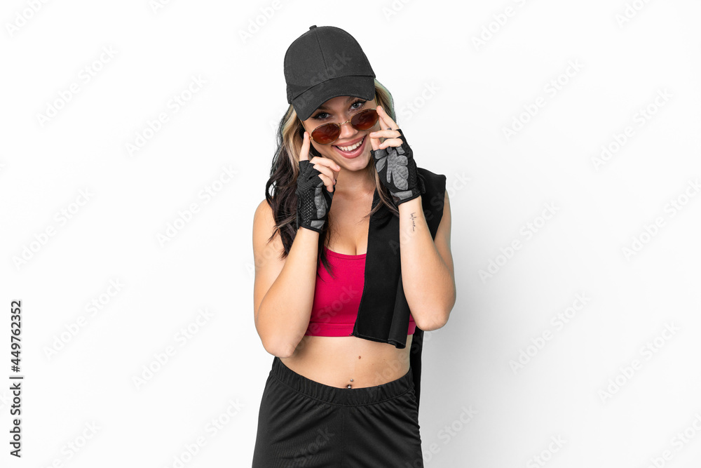 Sport Russian girl with hat and towel isolated on white background with glasses and surprised Sport Russian girl with hat and towel isolated on white background with glasses and surprised