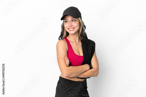 Sport Russian girl with hat and towel isolated on white background with arms crossed and happy