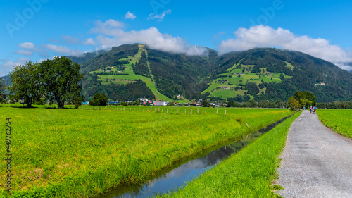 Broad mountain valley and water channel near Zell am See on sunny summer day. Austrian Alps, Austria