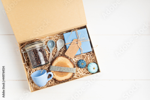 Preparing care package, seasonal gift box for coffee lovers. Personalized eco friendly basket for family and friends for christmas, thanksgiving, mothers day photo