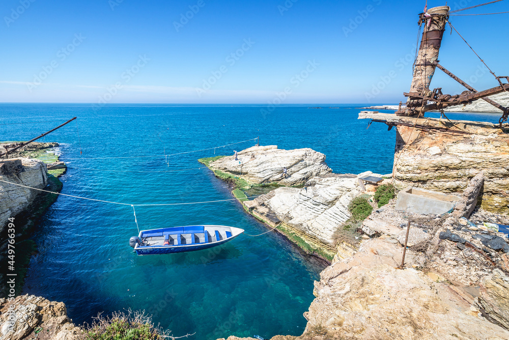 Naklejka premium Boat next to famous Pigeon Rock in Raouche district of Beirut capital city, Lebanon