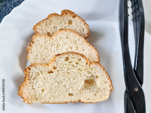 Slice of freshly cut bread on a white plate. photo