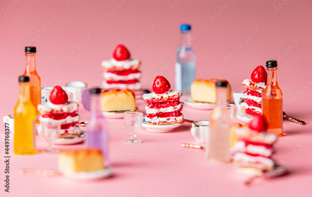 Miniature cakes and drink on pink background Miniature cakes and drink on pink background