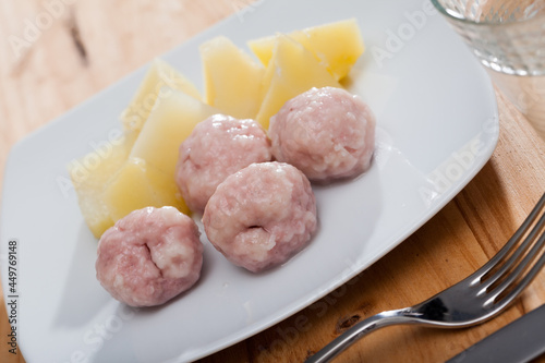 Steamed meatballs served on white plate with boiled potatoes. Concept of diet food