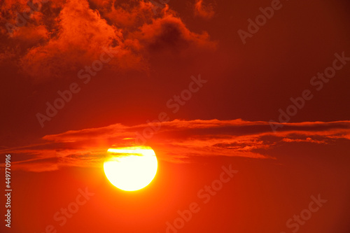 Setting sun in the clouds and red sky