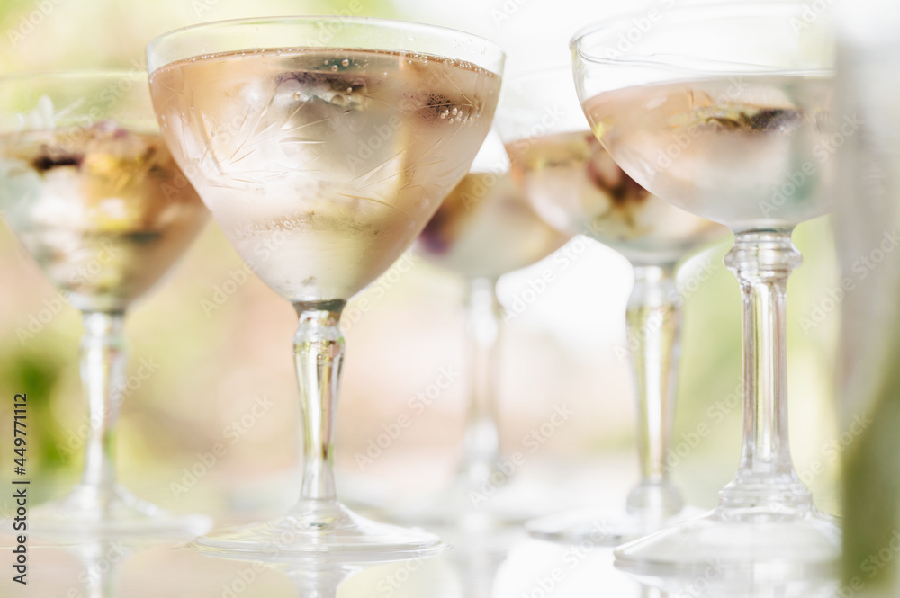 Sparkling rose wine with edible flower garnish Sparkling rose wine with edible flower garnish