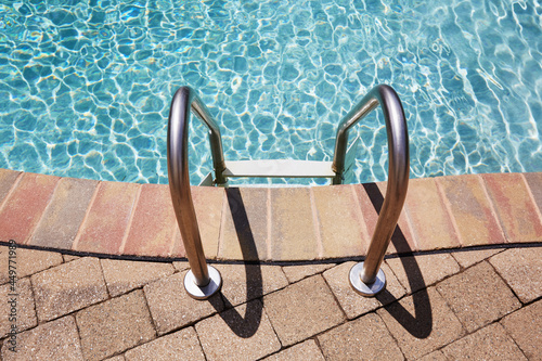 Ladder on swimming pool edge