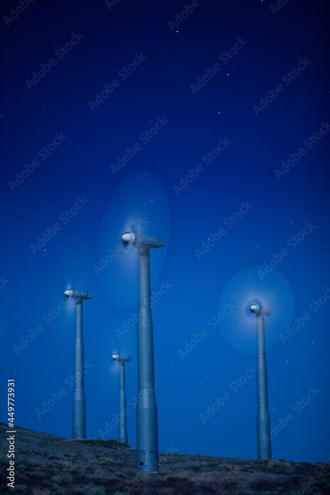 Wind turbines in landscape at night Wind turbines in landscape at night