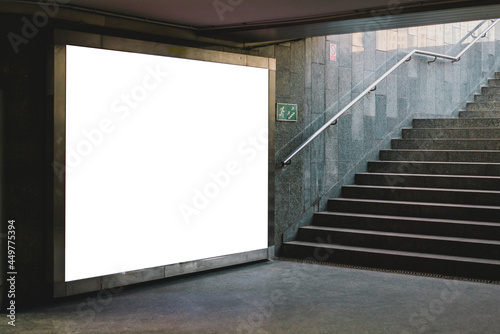 Blank white mock up billboard banner. Display in subway with stairs. Underground. Advertising. Ad. Horizontal. Transport