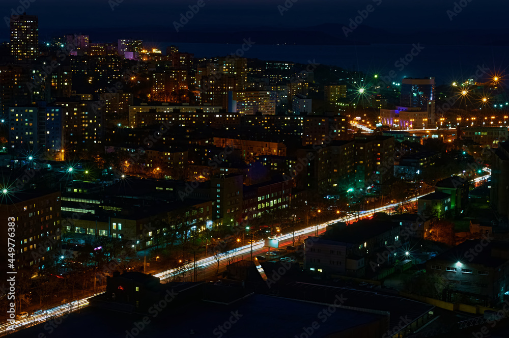 Aerial view of the night city of Vladivostok, Russia. Car traffic.