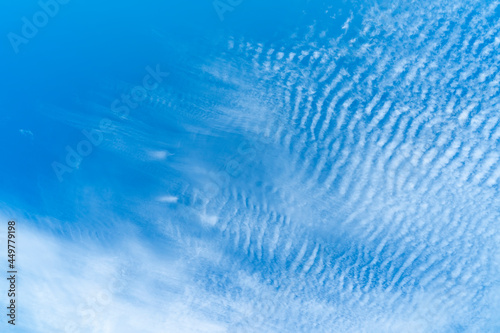 blue sky background with tiny clouds