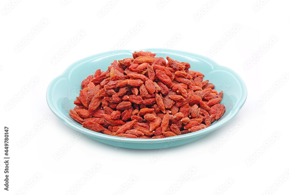 Goji berry in Chinese ceramic dish isolated on white background. Goji berry, or wolfberry. Used in traditional Chinese medicine and herbal tea ingredients , had anti-cancer properties. Goji berry in Chinese ceramic dish isolated on white background. Goji berry, or wolfberry. Used in traditional Chinese medicine and herbal tea ingredients , had anti-cancer properties.