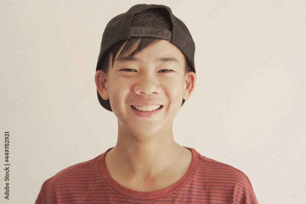 Head shot pov portrait of happy, confident and healthy mixed race  Asian preteen teen boy smiling face, youth day