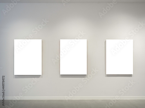 Photography Three mockup white blank museum art frames on white clean wall background with lighting