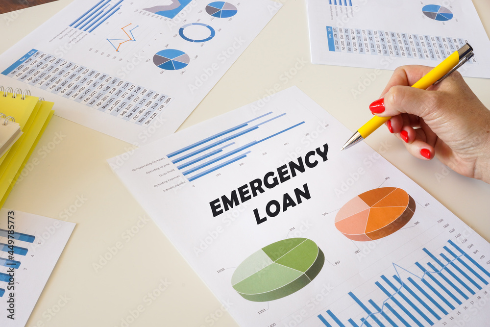 Financial concept meaning EMERGENCY LOAN with inscription on the printout with diagrams and tables.