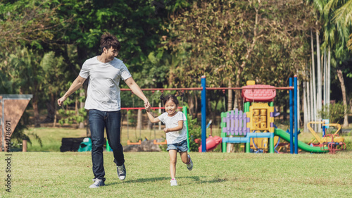 Banner photo of father running and playing with his daughter in the park