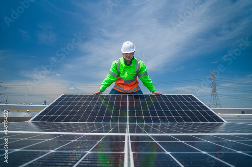 Engineer wearing unifrom and helmet inspect and check solar cell panel ,solar cell is ecology energy sunlight power installation for industrail ,alternative environment power concept.  photo