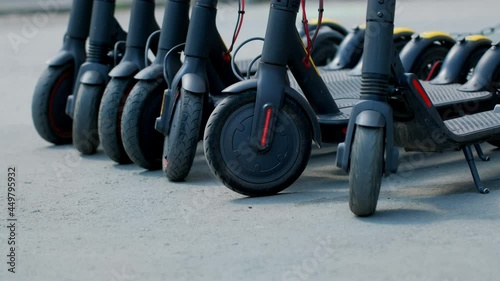 Scooter rental parking line. Eco vehicle 5g hotspot on e-board. Available electronic kick scooters urban passengers. Bicycle rent park with free wifi. Summer sharing for use a lot of people e-scooter.