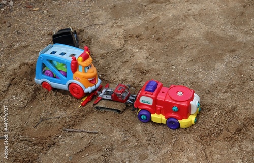 children's cars in the sandbox