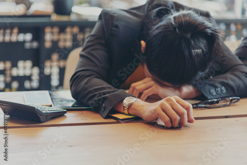 Asian businesswoman overworked at office stressful anxiety with serious problems. Woman exhaustion depress and mental burnout feeling tired frustrate at company office. Stress sadness contemplation