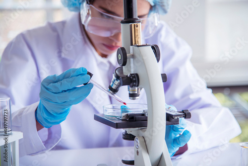 Woman scientist in lab look at science microscope medical test and research biology chemistry. Females technician laboratory analyzing scientific pharmacy genetic research. Chemistry Medical test lab photo