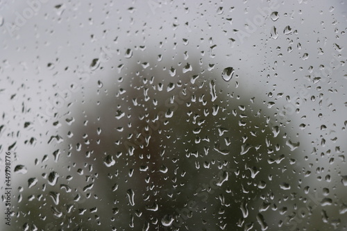 rain on the window in front of stormy background