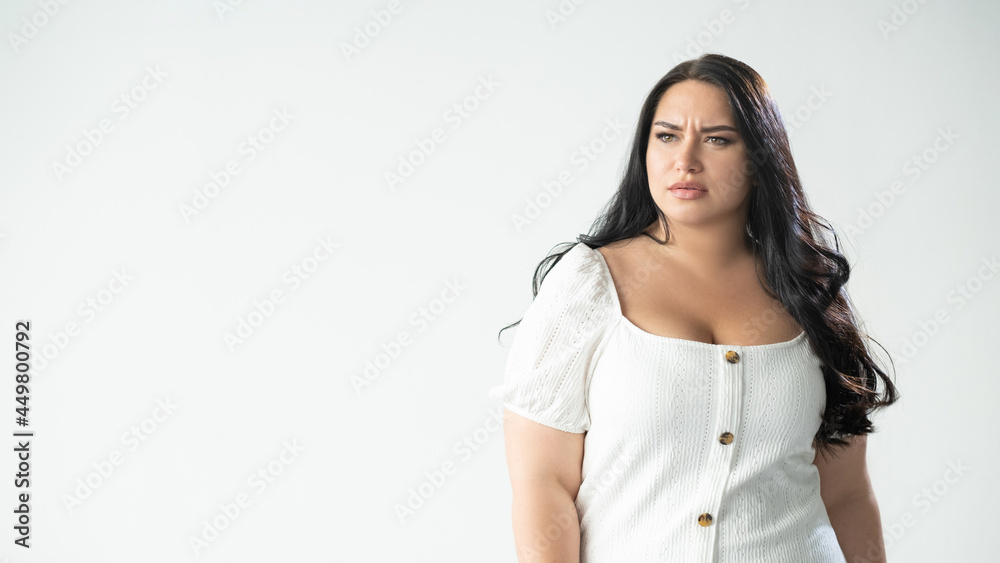 Body shaming. Upset woman. Social blaming. Psychology pressure. Advertising background. Sad worried plus size lady looking forward hesitating to go isolated white copy space.