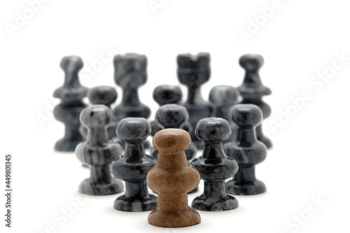 Chess pieces  white pawn leading black pieces