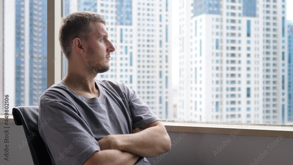 Overworked tired office man looking in the window. Stress at the workplace Overworked tired office man looking in the window. Stress at the workplace