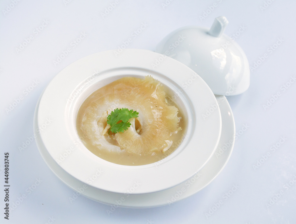 braised superior whole shark's fin thick soup with golden stock seafood in white background asian halal menu braised superior whole shark's fin thick soup with golden stock seafood in white background asian halal menu