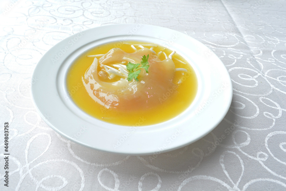 braised superior whole shark's fin thick soup with golden stock seafood in white background asian halal menu braised superior whole shark's fin thick soup with golden stock seafood in white background asian halal menu