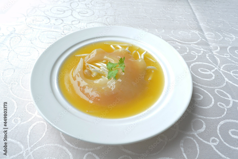 braised superior whole shark's fin thick soup with golden stock seafood in white background asian halal menu braised superior whole shark's fin thick soup with golden stock seafood in white background asian halal menu